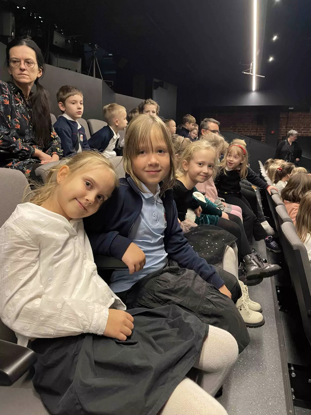 Uczennice klasy 1c na widowni Teatru Pinokio podczas spektaklu "Dziadek do orzechów"