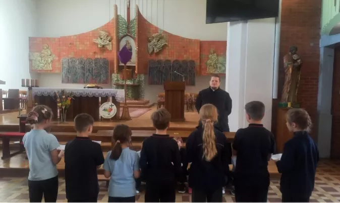 uczniowie i nauczyciele składają życzenia ks.Pawłowi