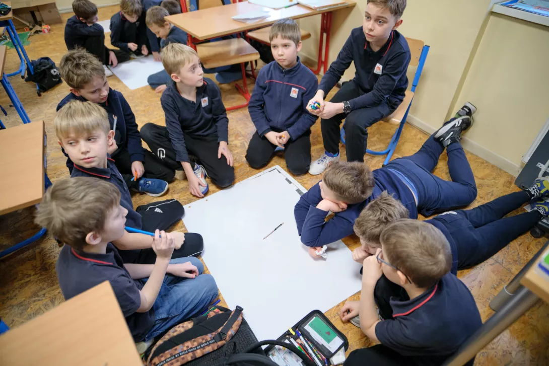 Uczniowie szkoły podstawowej pracują nad plakatem o Ks. Bosko, podczas lekcji prowadzonej przez liceum. (fot. Amelia Szymańska)