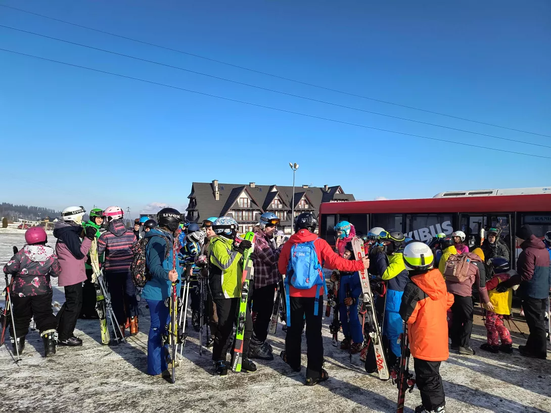 Zimowisko 2025, grupa wysiada ze skibusa